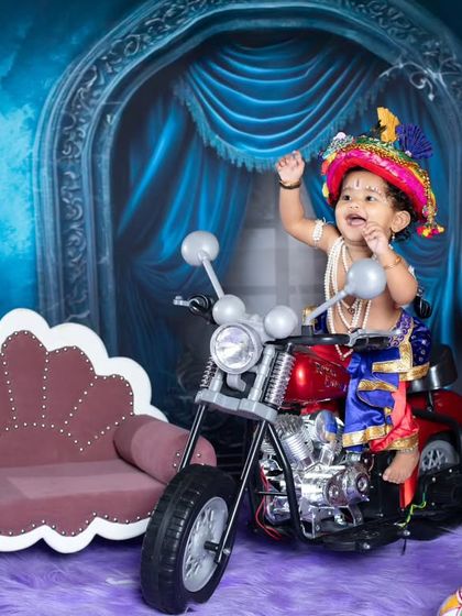 A happy little Krishna on his motorcycle, waving to his devotees.