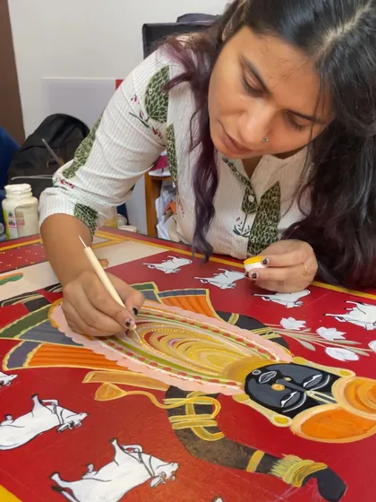 Every detail matters. Here, I'm adding the finishing touches to a custom Pichwai painting. This is where I get lost in the process, ensuring every line and colour tells the client's story with care and precision.