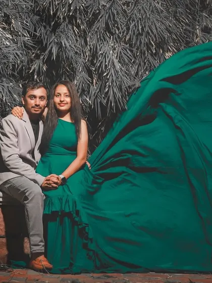 A dramatic "flying gown" shot for a pre-wedding photo. The long green trail creates a stunning wing-like effect, perfect for a memorable picture.