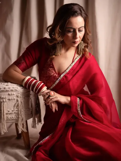 A quiet moment of reflection. For this editorial shoot, we focused on soft lighting and a gentle mood to complement the elegance of the red saree, creating a frame that feels both timeless and deeply personal.