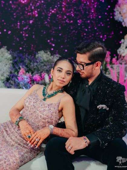 A stylish portrait of the couple. The bride's sleek ponytail and glam makeup are perfect for a modern reception.