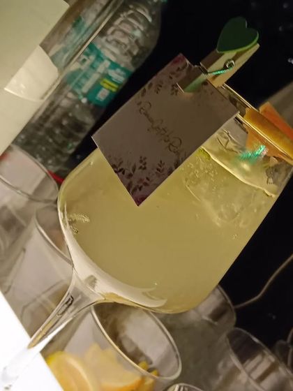 A refreshing cocktail served with a custom tag, showing how even simple garnishes can be personalized.