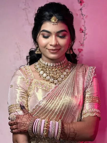 A beautiful, serene portrait of the bride, with a soft pink background.