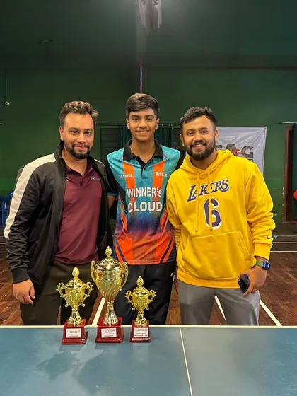Aakash with his coaches and his impressive haul of trophies after winning both the Men's Singles and Under 19 Boys titles at the State Championship.