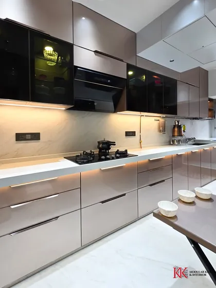 Another view of our Kalpataru Heights project, showcasing the seamless integration of cabinets and appliances in a parallel layout. The under-cabinet lighting brightens the workspace and highlights the elegant glass finish.