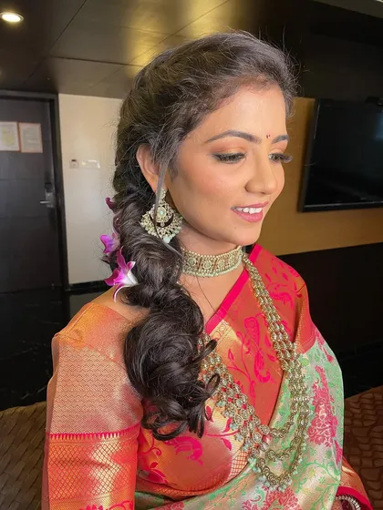 A beautiful engagement look with a soft, braided hairstyle and glowing makeup.