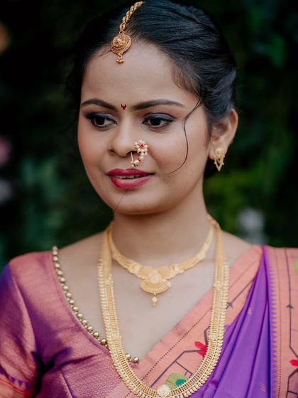 A simple and elegant portrait of a Marathi bride. The makeup is kept minimal and clean to let her natural beauty and traditional gold jewelry shine.