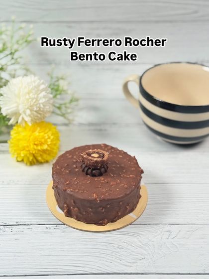Our Rusty Ferrero Rocher Bento Cake is a little box of luxury. It captures the iconic hazelnut and chocolate flavor in a perfect, personal-sized portion.