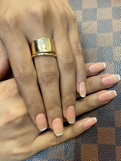Another angle showcasing these perfectly glossy and timeless French tips. This look is ready for any occasion, from a business meeting to a wedding.