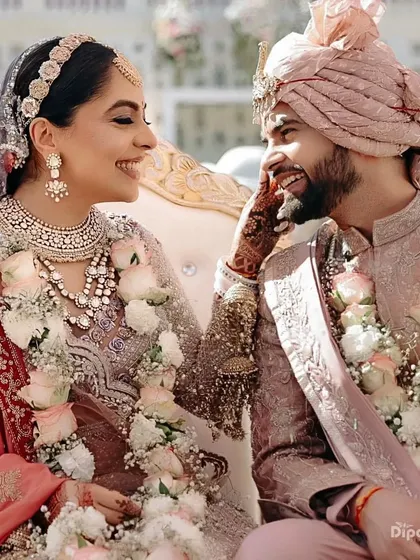 A candid, happy moment between the bride and groom. Her mehendi-adorned hand adds a touch of tradition and beauty to the interaction.