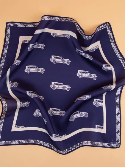 A draped shot of the vintage car pocket square, showing the fabric's texture and sheen.