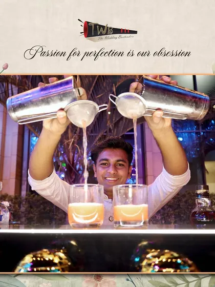 The dual pour. One of our skilled bartenders expertly pours from two shakers at once, a display of skill and efficiency that keeps the drinks flowing at a busy Sangeet.