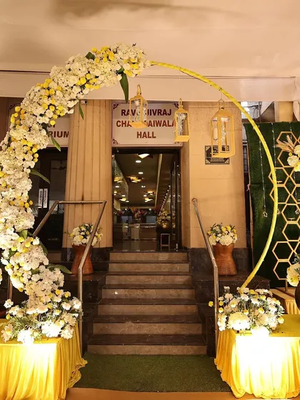 The entrance to the Mehendi hall, decorated with a beautiful arch of white and yellow flowers to welcome guests.