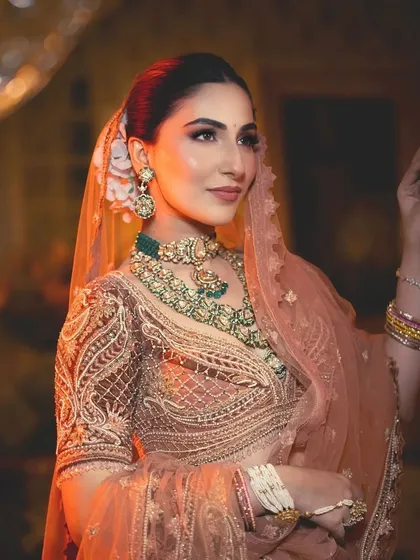 The same bride, exuding warmth and elegance. The styling focuses on a soft, romantic color palette perfect for a day function.