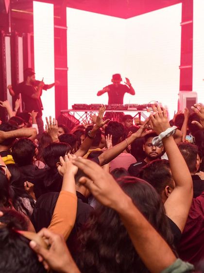 A view from the crowd, looking up at the DJ booth.