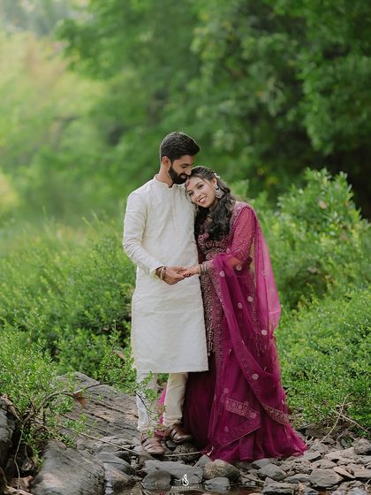 A tender moment with her resting her head on his shoulder. This pose is full of warmth and affection.