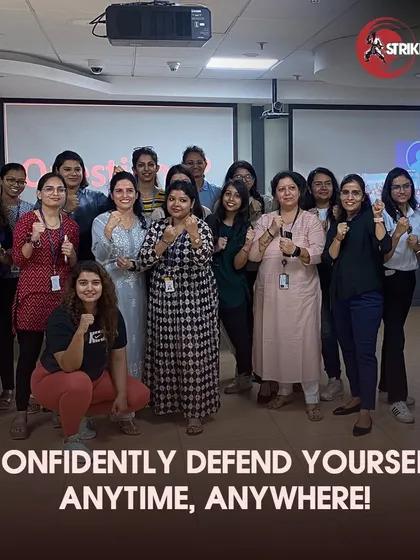 A group of empowered employees poses together after a successful corporate wellness session. Our workshops are not just about learning moves; they are about building team morale, fostering a sense of security, and creating a more confident workforce.