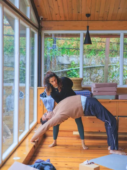Assisting a student in Urdhva Dhanurasana (Wheel Pose). With the right support, we can explore backbends with more confidence and openness.