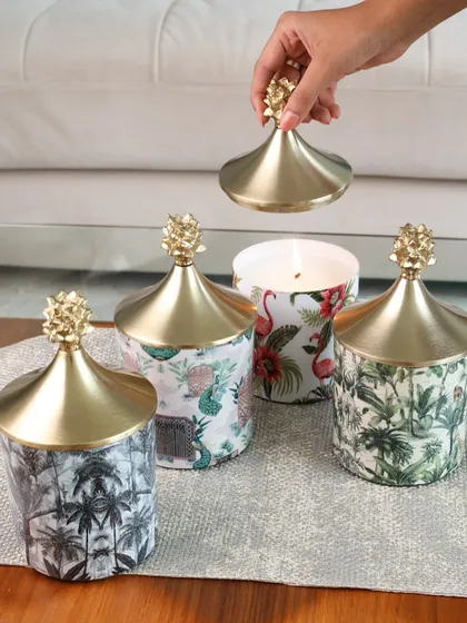 Our collection of assorted printed scented candles, each topped with a chic gold pineapple lid. These are designed to be mixed and matched for a playful and stylish display.