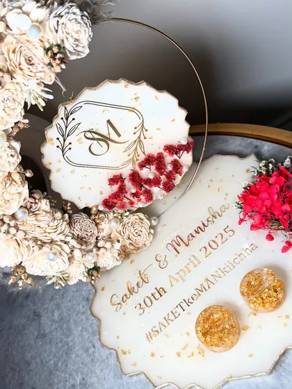 The complete beige-themed ring platter set. It includes the main tray and a hanging floral hoop with the couple's monogram, creating a coordinated look.