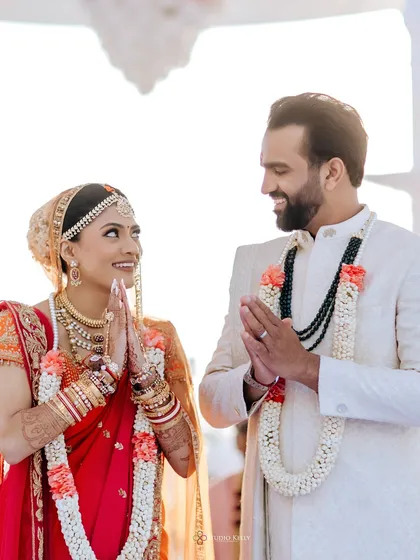 The couple shares a traditional greeting during their Hindu wedding ceremony in Vietnam, a beautiful blend of cultures.