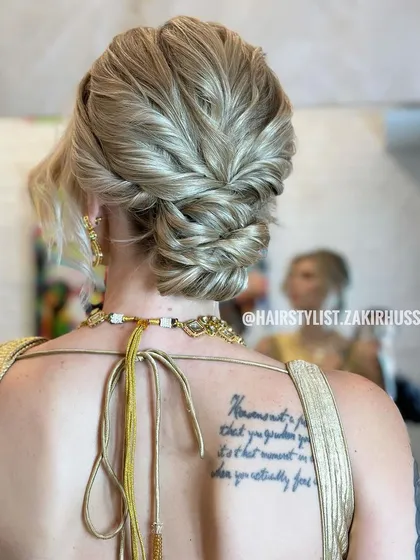 This textured updo was created for an international bride, showcasing how I adapt my techniques for different hair types, including blonde hair. The style features interwoven sections and a soft, romantic finish suitable for a wedding ceremony or reception.