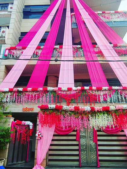 A daytime view of the elegant pink house draping, showing the beautiful floral borders and clean lines of the design.