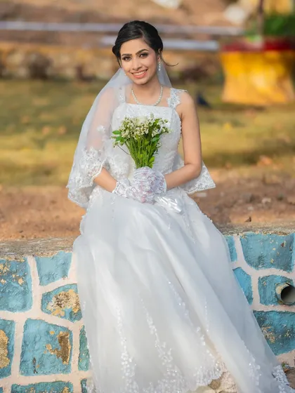 A serene portrait of the bride. The soft makeup and simple bouquet create a look of pure and simple beauty.