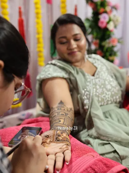 A candid shot of me applying a detailed design for a member of the bridal party.