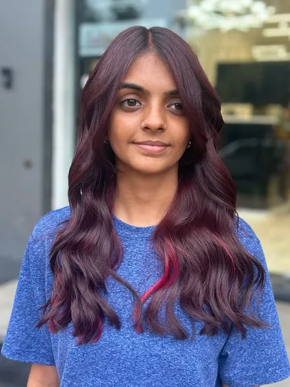 A front-facing view of the beautiful vine hair color. The shade is deep and luxurious, and the subtle pink highlight adds a pop of fun.
