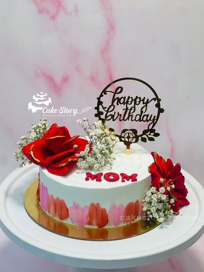 A beautiful floral cake for a loving mom. The simple design is elevated with a red brushstroke effect and elegant fresh flowers.