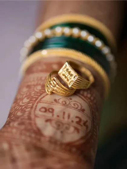 The little things tell a big story. This creative detail shot places the engagement rings over the wedding date written in henna, a unique and personal way to remember the beginning of your forever.