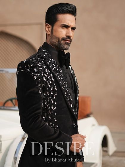 Another angle of the black velvet tuxedo, showcasing the way the silver embroidery catches the light. This is a look designed to shine.