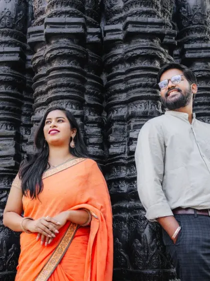 A confident and stylish pose against an ancient-looking temple wall. This pre-wedding shot mixes traditional elements with modern couple portraiture for a unique and striking result.