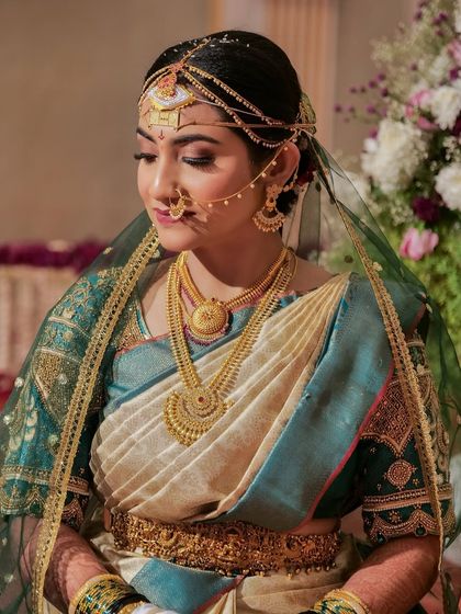 A closer view of the Coorgi bride. Her makeup features defined eyes and a soft lip, with a flawless base that enhances her natural complexion.