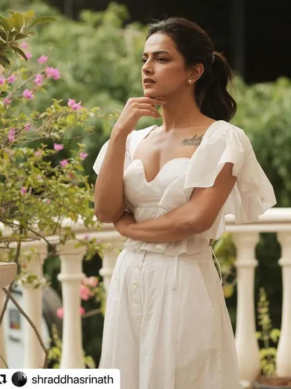 A three-quarter view of the white ensemble styled for Shraddha Srinath, showing how the pieces create a flattering and graceful silhouette.