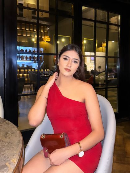 A classic portrait in the red dress, looking poised and elegant.