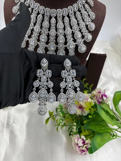 A close-up of the intricate, chandelier-style earrings that come with the cascading AD necklace.