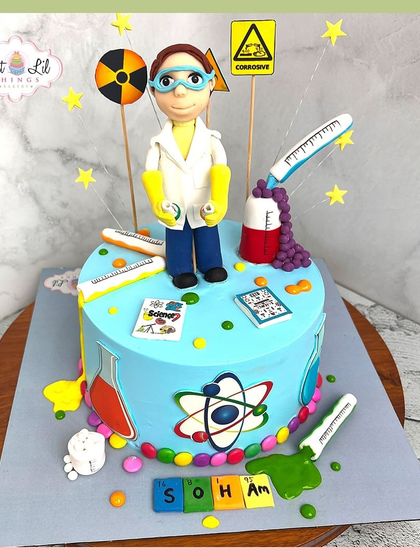 A fun and educational science-themed cake. This creation is perfect for a budding scientist, with beakers, atoms, and a fondant figure in a lab coat.