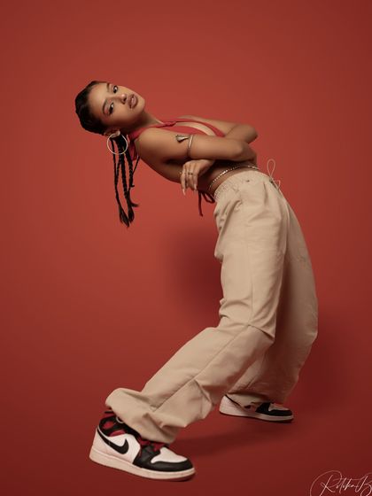 A full-body shot in a dynamic, bent-back pose, showing my flexibility and the lines I can create as a dancer.