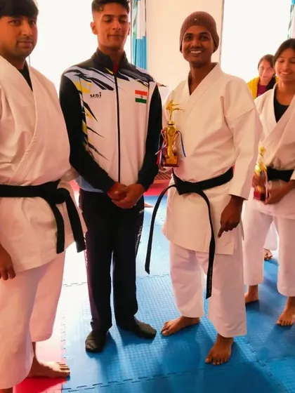 Two of our senior students who successfully passed their black belt examination, seen here with their awards.