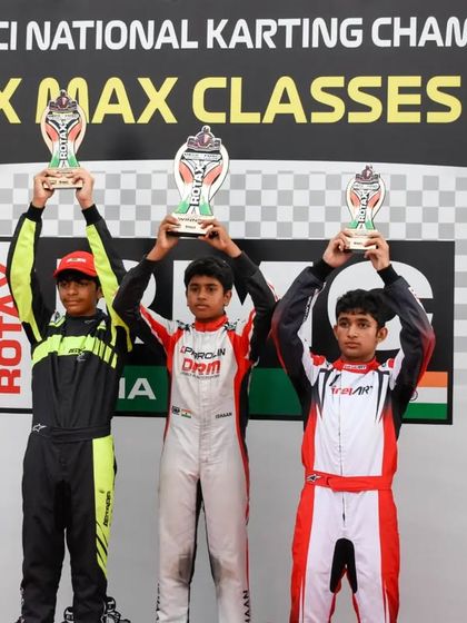 Our drivers celebrating their victories at the MECO-FMSCI National Karting Championship Rotax Max Classes 2023, holding their trophies high.
