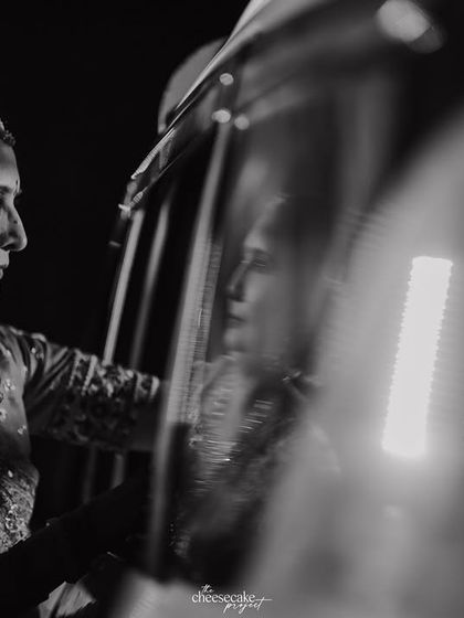 The mother of the bride watching the Vidaai car depart, a poignant and reflective moment.