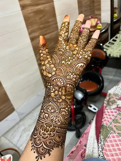 A full-hand design with intricate floral and paisley patterns.