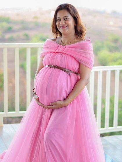 This off-shoulder pink maternity gown is simple, elegant, and incredibly flattering. The bow detail at the bust adds a sweet touch.