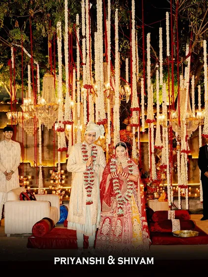 The newlyweds, Priyanshi and Shivam, share their first moments as a married couple. They stand under a breathtaking mandap of cascading flowers and chandeliers, a perfect start to their journey.