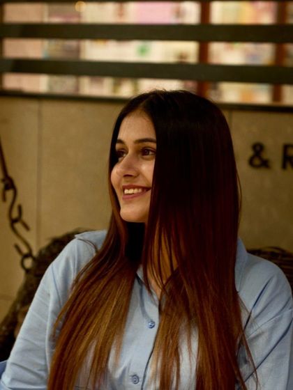 A beautiful shot of a client with long, healthy hair, smiling and feeling great after her salon visit.