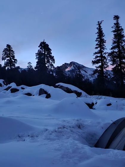 Our tent at dusk, dug into the snow for protection. Moments like these are part of the magic of winter trekking. It's a peaceful, challenging experience that your body needs to be ready for.