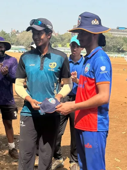 A moment of sportsmanship as our player presents a cap to a member of the Ontario Cricket team.