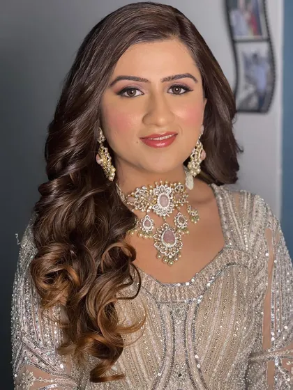 Ural's radiant smile completes the look. The makeup enhances her features without masking her natural beauty.